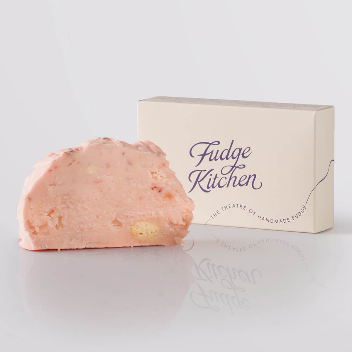 Strawberry Cheesecake Fudge single slice, a Fudge Kitchen indulgent, handmade fudge flavour displayed with an elegant gift box.