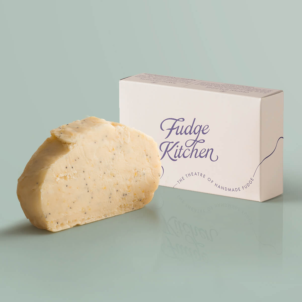 Vegan Fudge Lemon Drizzle Fudge single slice, a Fudge Kitchen indulgent, handmade vegan Fudge flavour displayed with an elegant gift box.