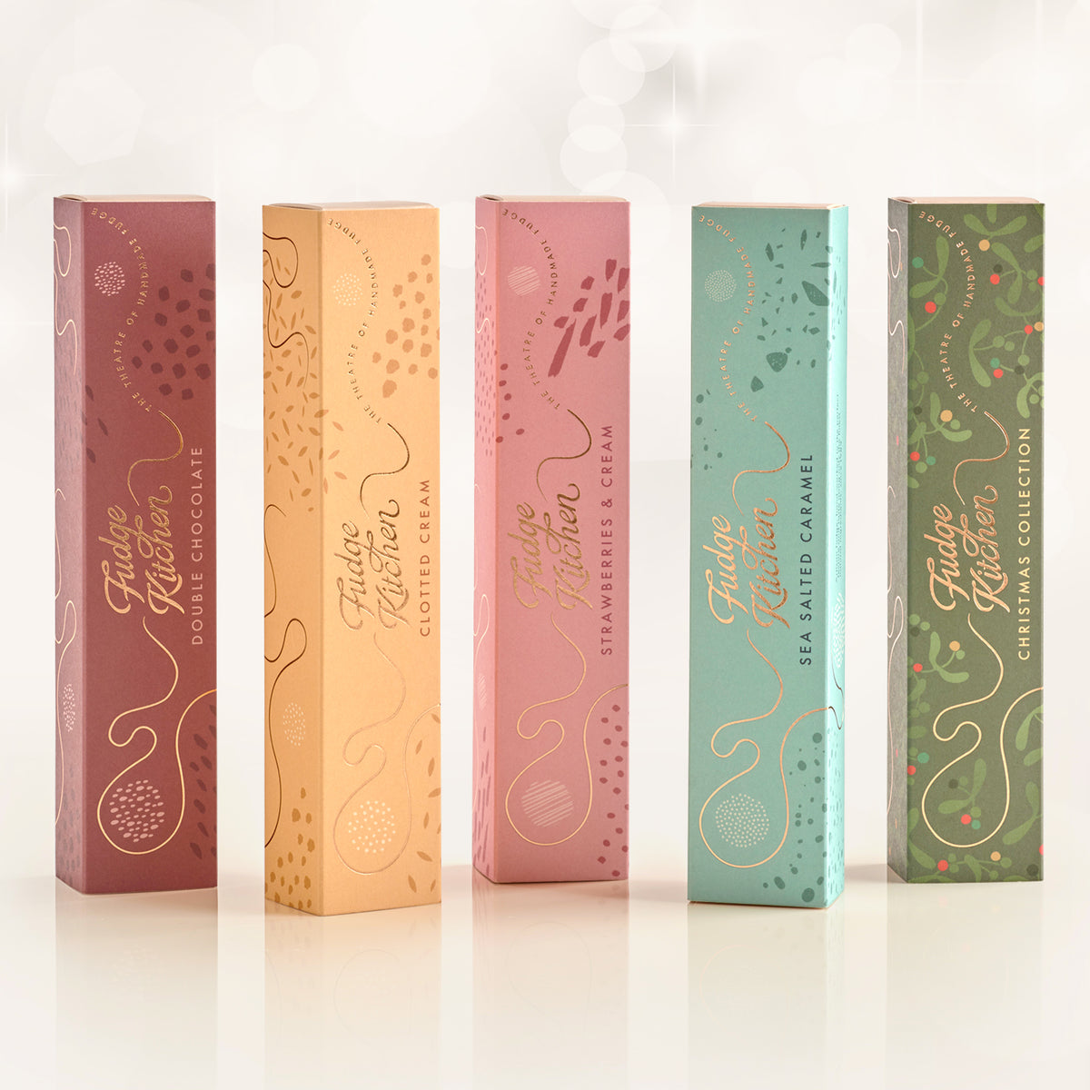 Five Fudge Kitchen fudge slider gift boxes in different colours on a white background