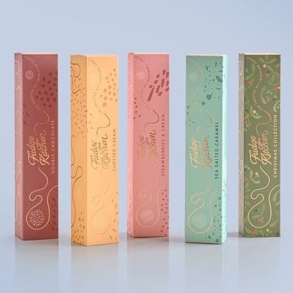 Five Fudge Kitchen fudge gift slider selection boxes in different colours on a light blue background.