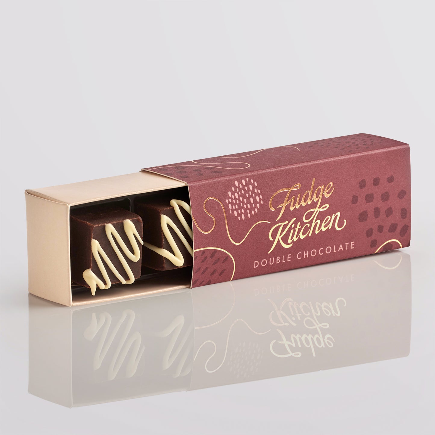 Open box of Fudge Küchen double chocolate fudge on a light gray background