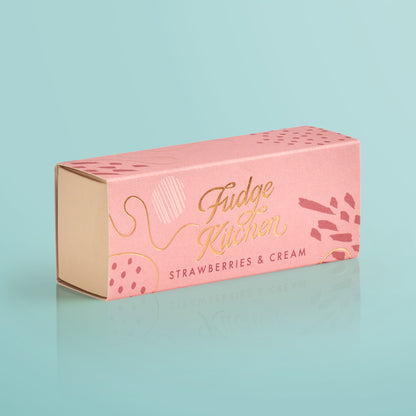 Pink fudge box with 'Fudge Kitchen' and 'Strawberries & Cream' text on a light blue background