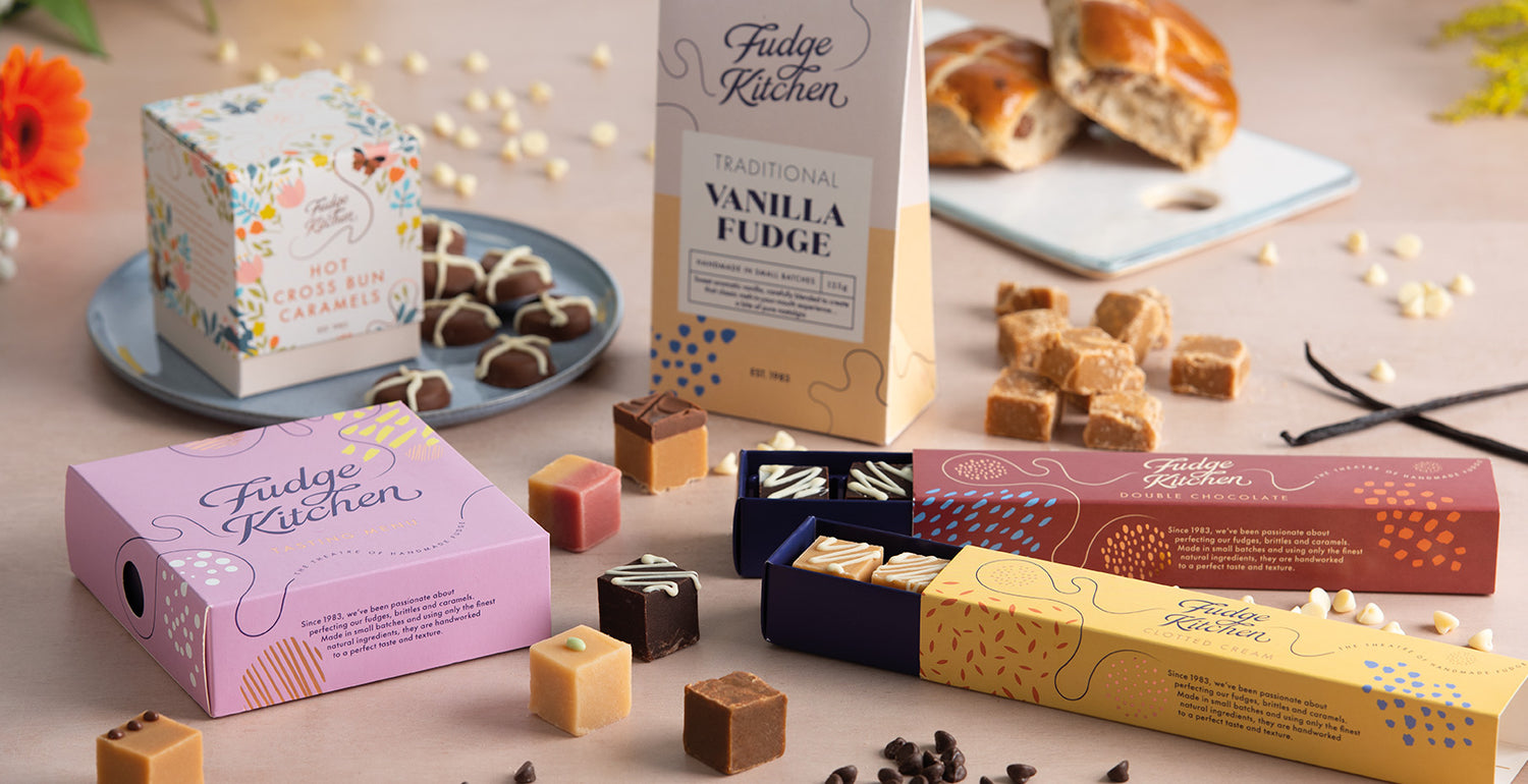 Fudge Kitchen seasonal spring fudge boxes and fudge pieces and caramels on a table with a blurred background