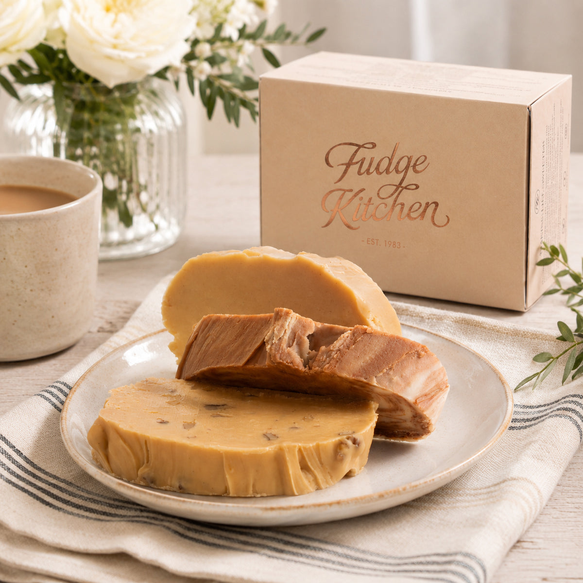 Classic fudge trio presented in an elegant buff-coloured gift box with gilded accents.