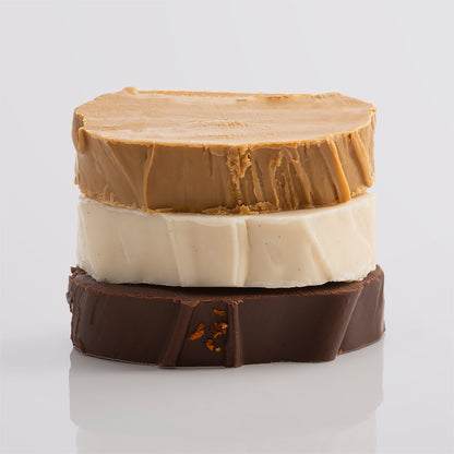 A stack of creamy vegan fudge slices in warm, rich tones.