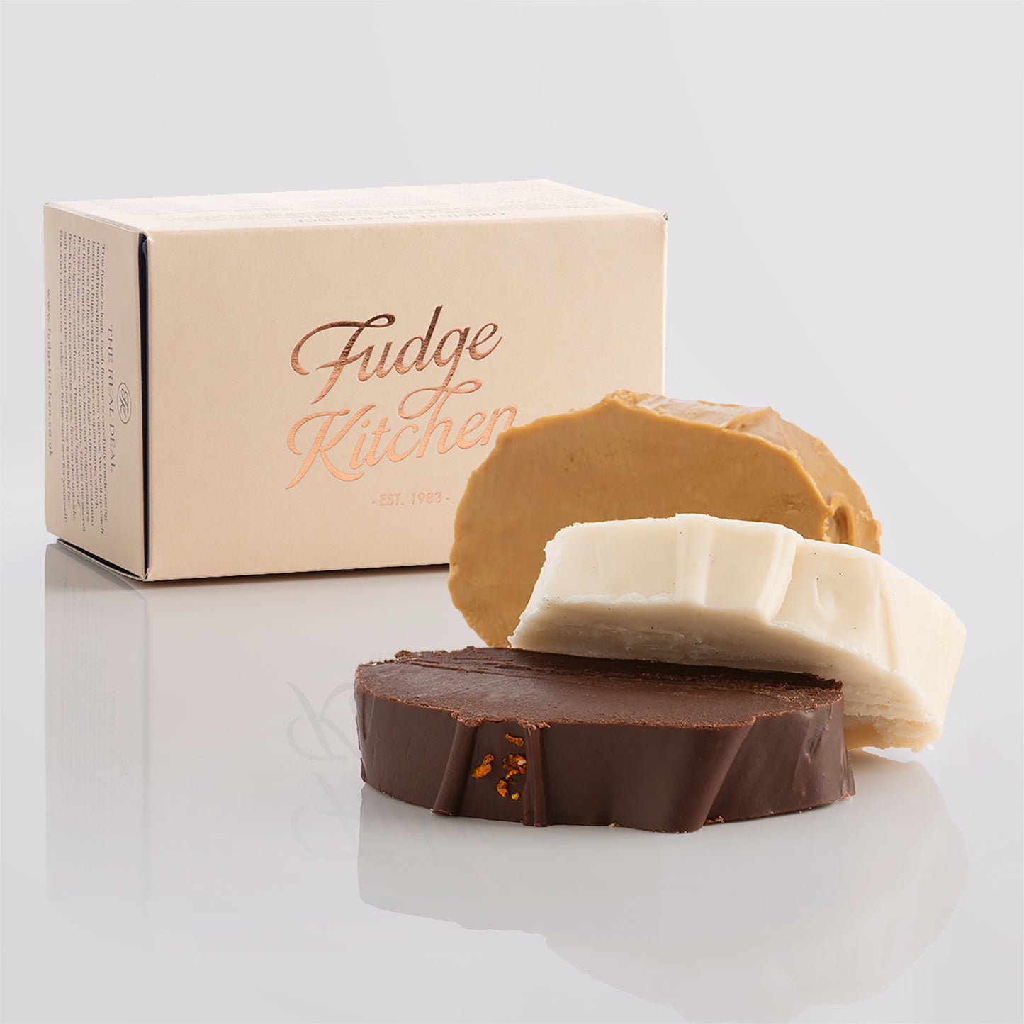 Vegan fudge trio elegantly displayed in a buff-coloured gift box with gilded accents.