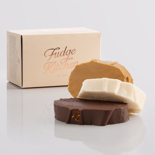 Vegan fudge trio elegantly displayed in a buff-coloured gift box with gilded accents.