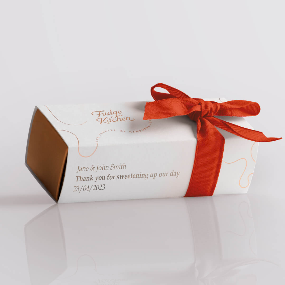 Wedding favour box from Fudge Kitchen, featuring a personalised message and wrapped with a red ribbon, perfect for gifting handmade butter fudge.
