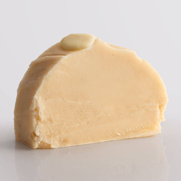 White Chocolate Fudge, a Fudge Kitchen indulgent, handmade fresh fudge flavour shown in a single slice.