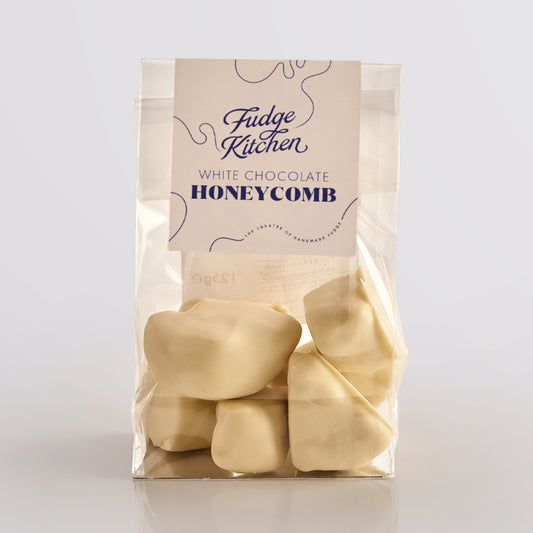 White chocolate honeycomb by Fudge Kitchen, featuring crisp, golden honeycomb pieces coated in rich white chocolate. A perfect sweet treat or gift for honeycomb and chocolate lovers.