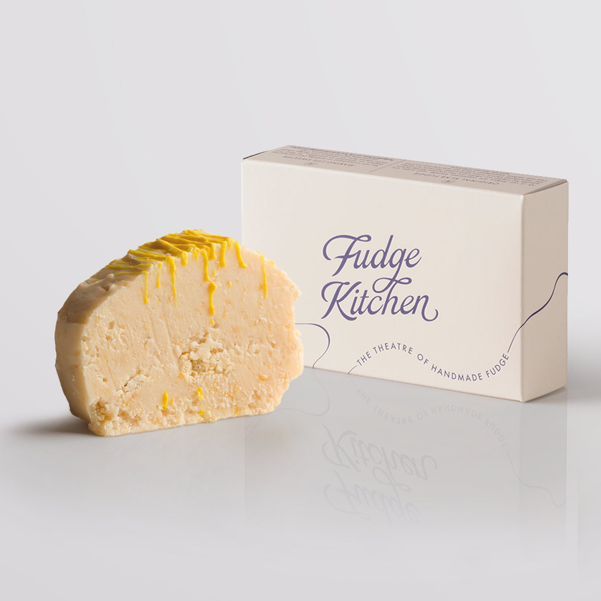 Lemon Cheesecake Fudge single slice, a Fudge Kitchen indulgent, handmade fudge flavour displayed with an elegant gift box.