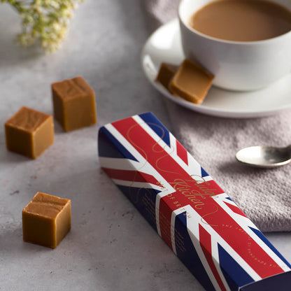 Best of British Fudge Slider by Fudge Kitchen, featuring premium handcrafted Fudges in classic vanilla toffee fudge flavour displayed on a table with a cup of english tea.